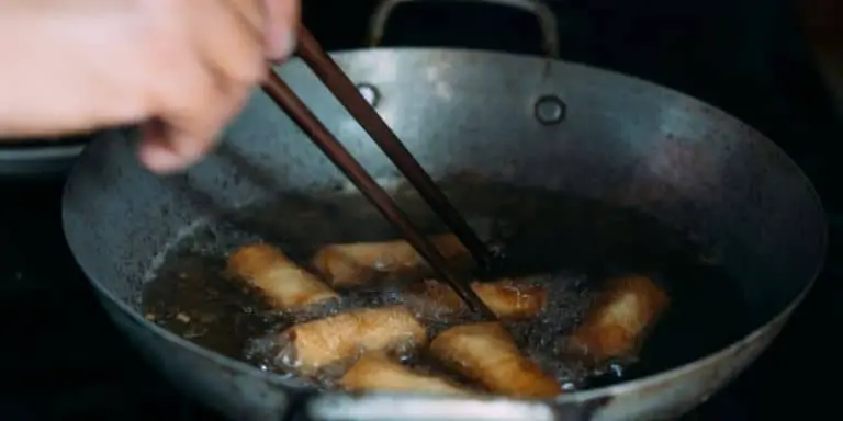Stirring spring rolls in a pan