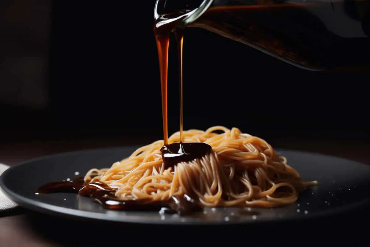 Soy sauce pouring on fresh pasta