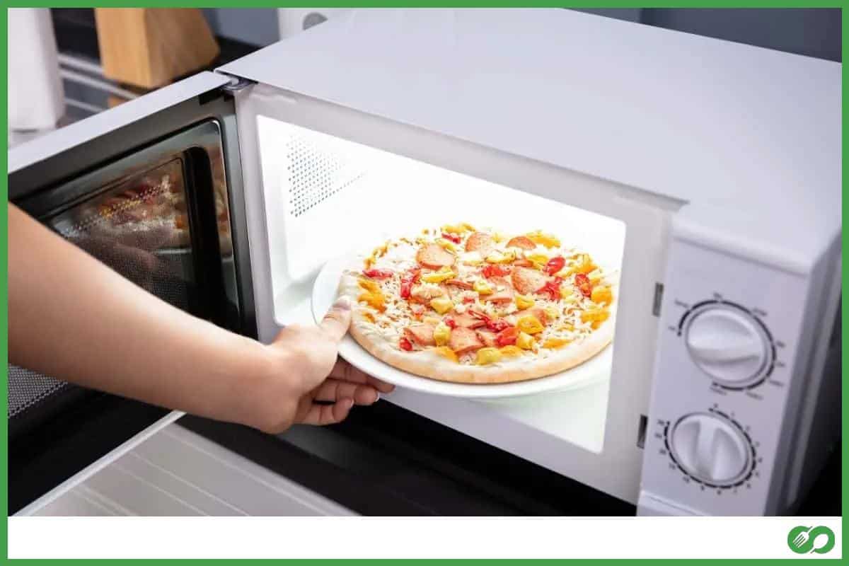 Woman baking pizza in the microwave