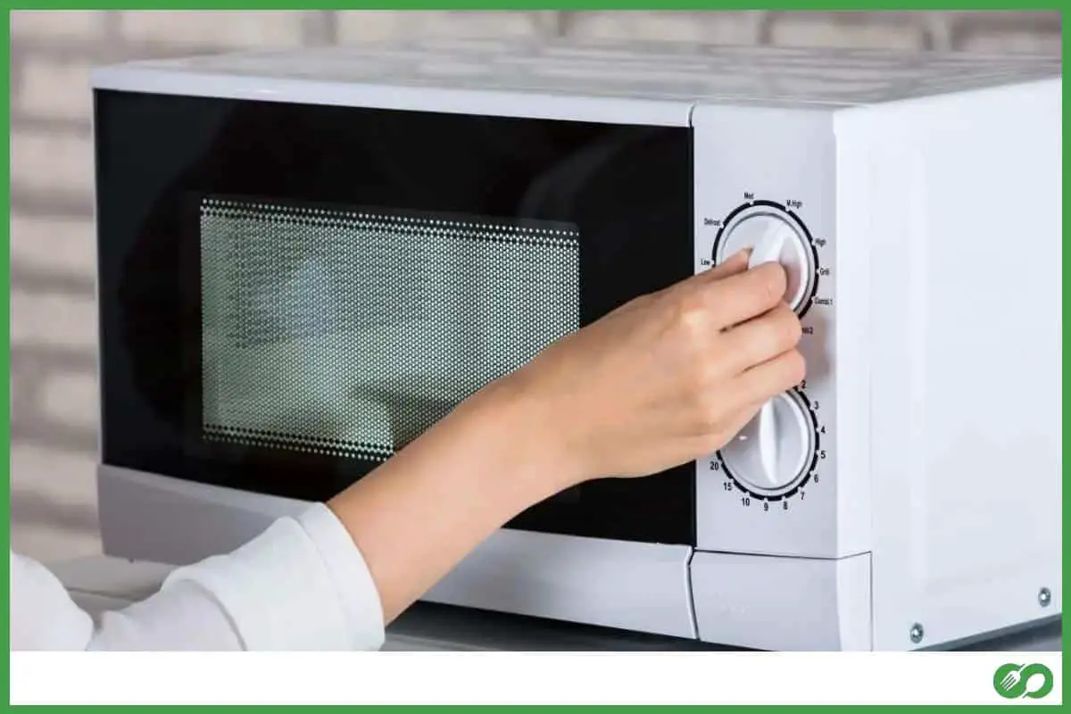Woman using a microwave oven